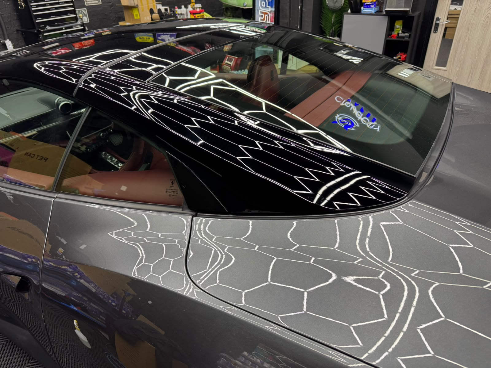 Reflection check on a Ferrari roof and rear quarter after refinishing